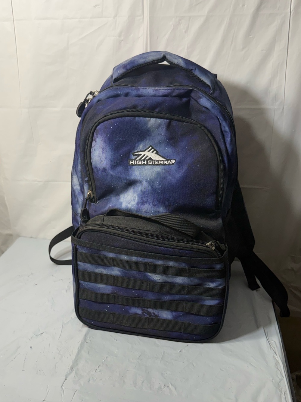High Sierra Joel backpack and matching lunch kit in a blue space galaxy design